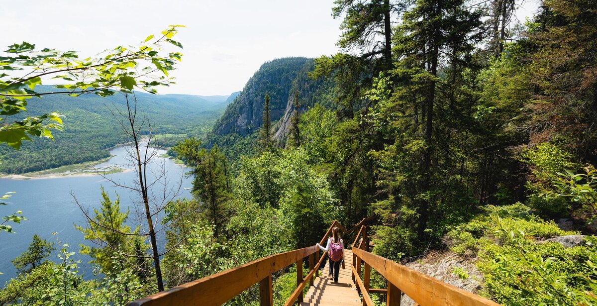 Hikers in forest overlooking the Saguenay Fjord