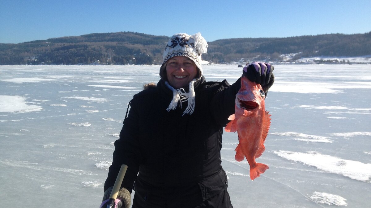 Ice fisherwoman with a redfish