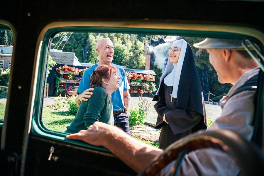 View from a vintage car of visitors at Val‑Jalbert village