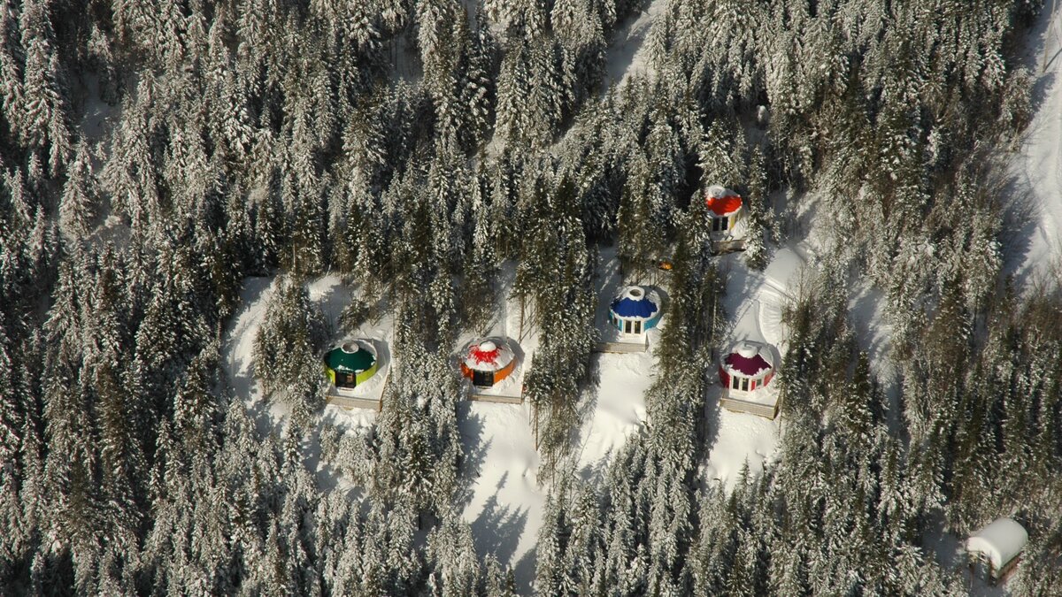 Aerial view of the yurts of Imago Village in winter