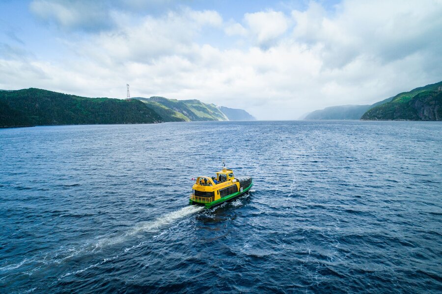 Shuttle on the Saguenay Fjord between steep cliffs